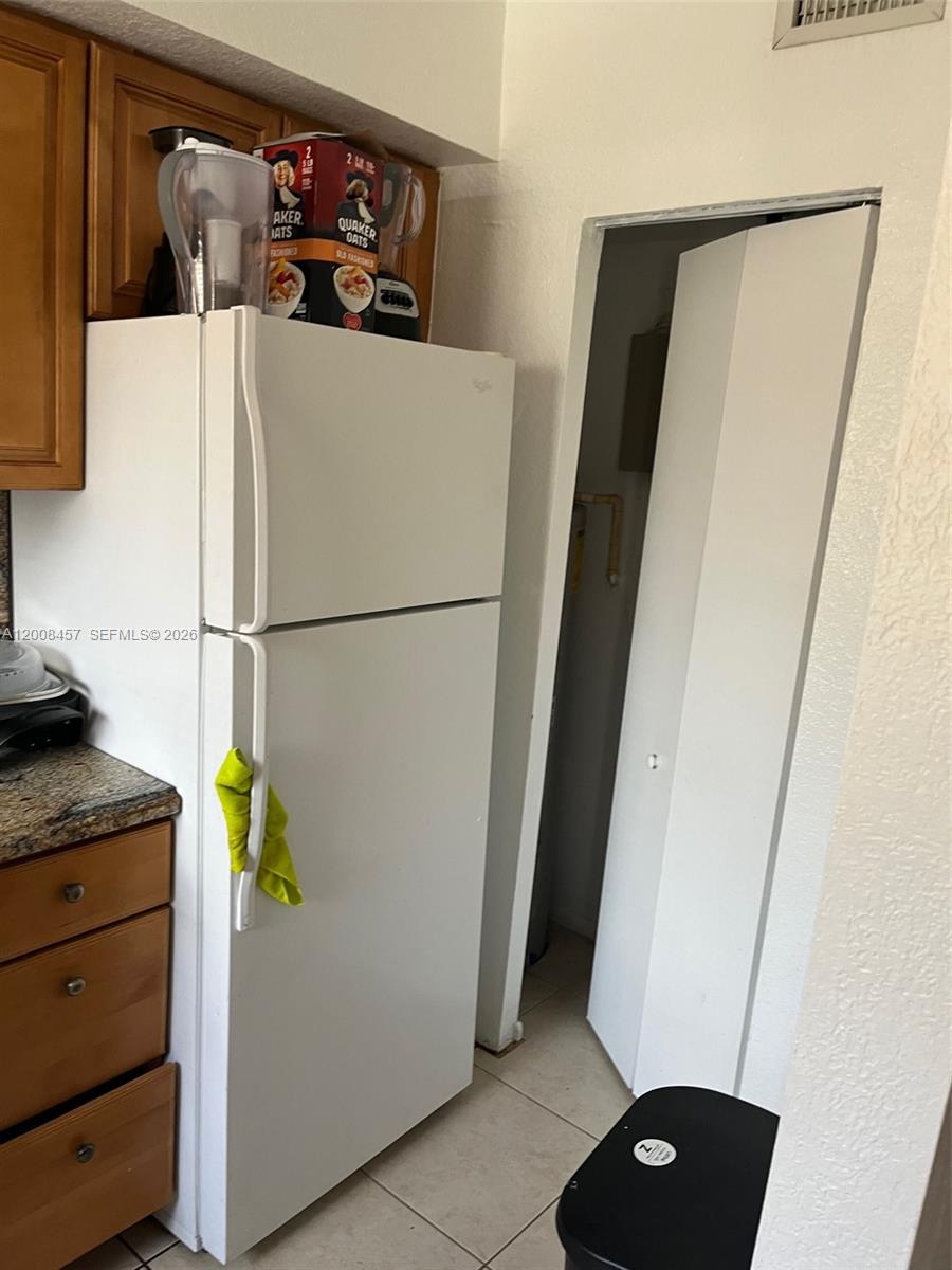 403 Northwest 84th Street, Unit 403 Miami, FL 33150 - Photo 2 of 5 a white refrigerator freezer sitting inside of a kitchen