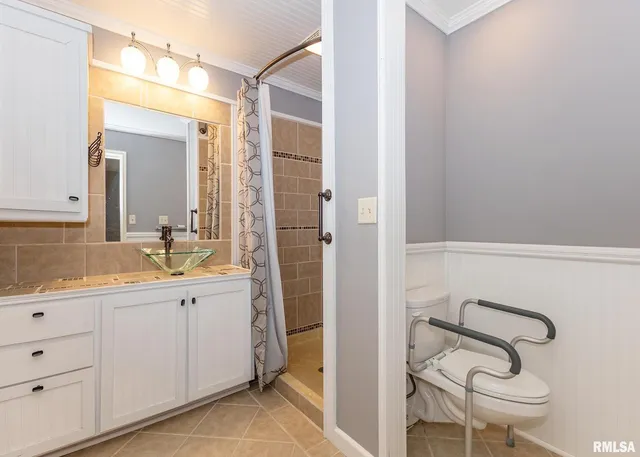 a bathroom with a double vanity sink a toilet and a mirror