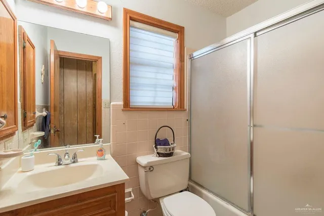 a bathroom with a sink toilet and a mirror