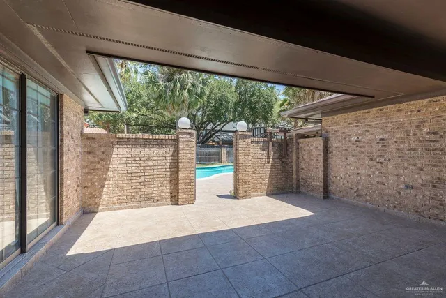 a view of a room with wooden walls and a large window