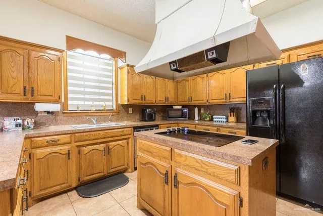 a kitchen with a stove a sink and a microwave
