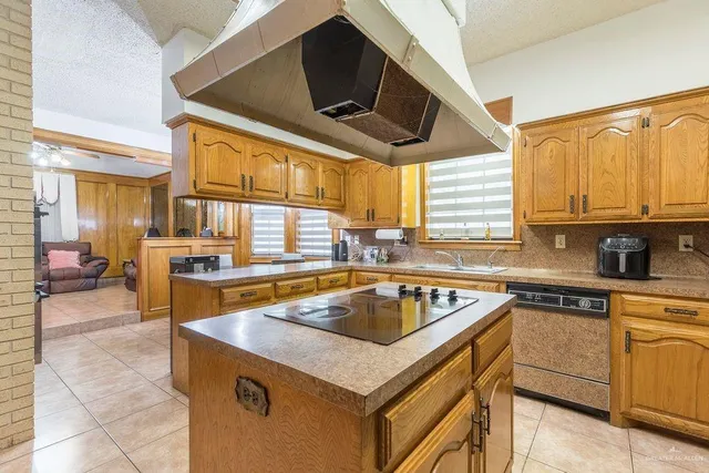 a kitchen with a stove a sink and a microwave