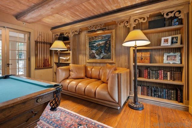 a living room with furniture a rug and a window