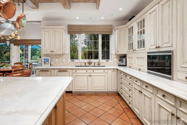 a kitchen with granite countertop white cabinets and white appliances
