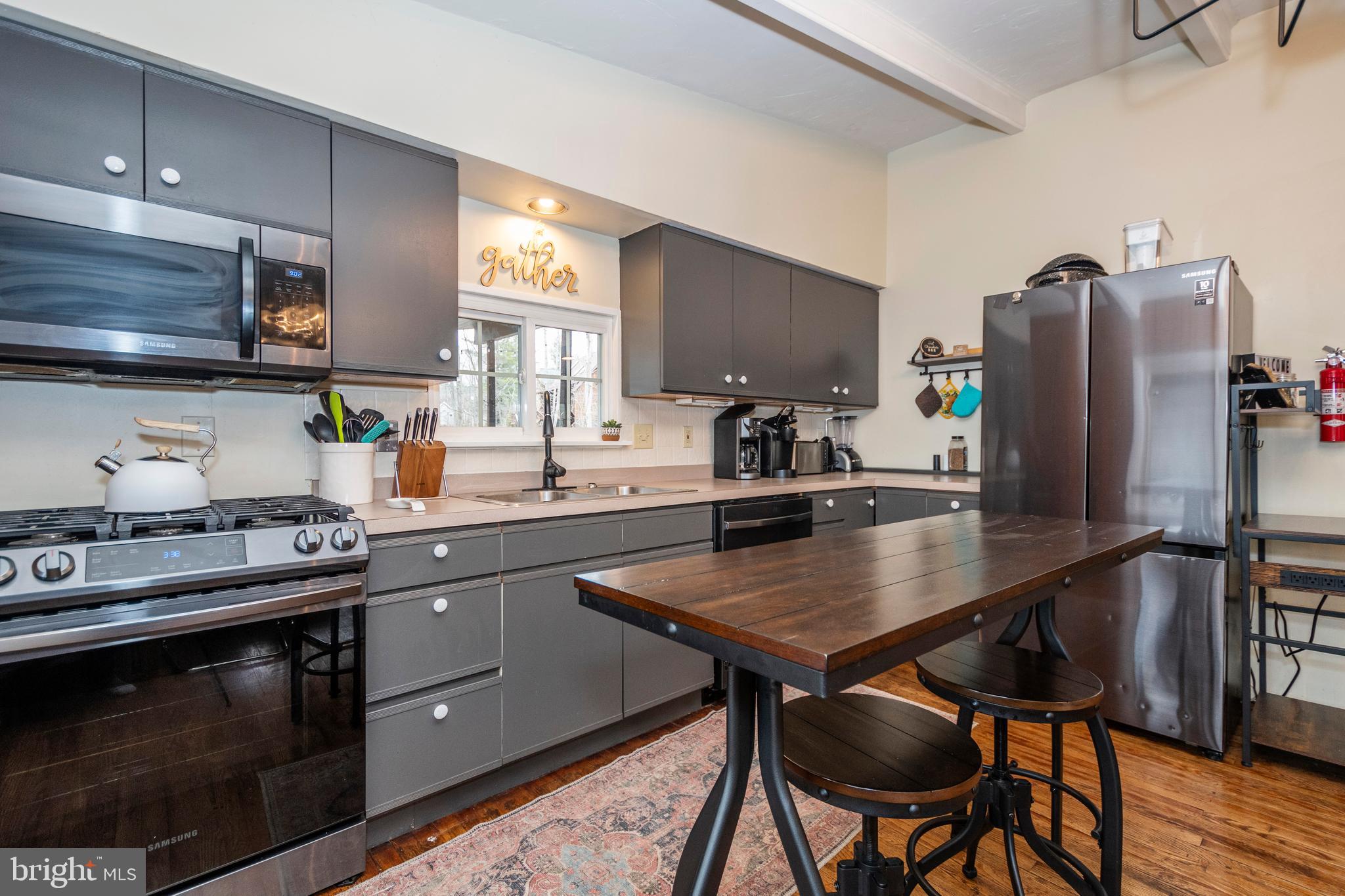 16 Jrs Drive McHenry, MD 21541 - Photo 30 of 57 a kitchen with stainless steel appliances granite countertop a stove a refrigerator a sink a dining table and chairs with wooden floor