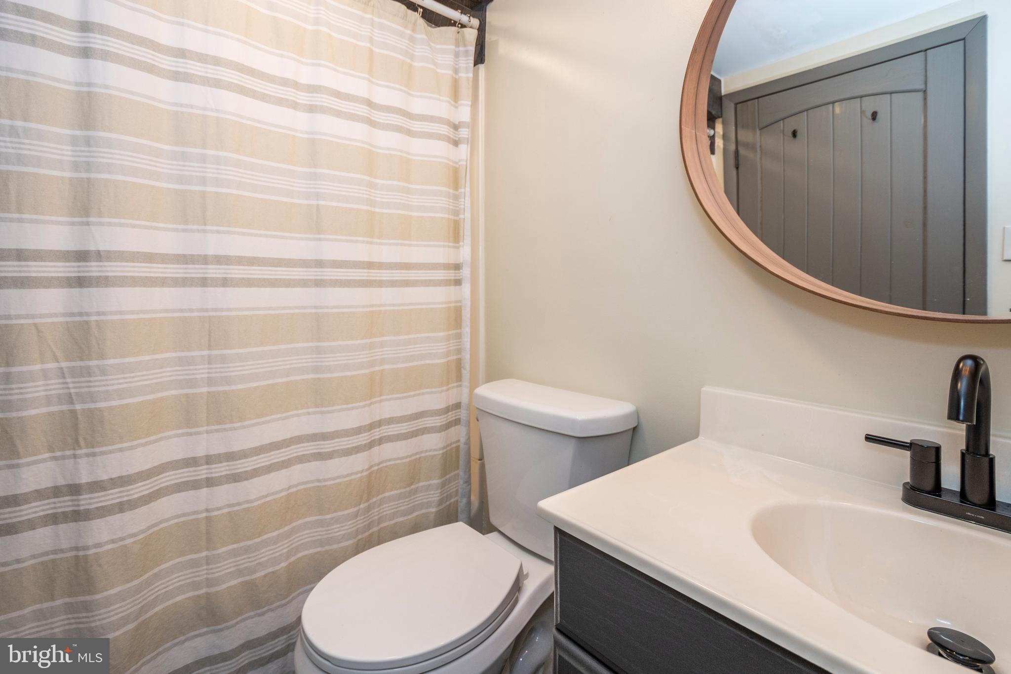 16 Jrs Drive McHenry, MD 21541 - Photo 37 of 57 a white toilet sitting next to a bathroom sink