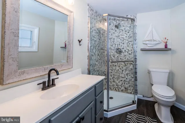 a bathroom with a toilet sink and mirror