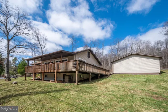 a front view of a house with a yard table and chairs