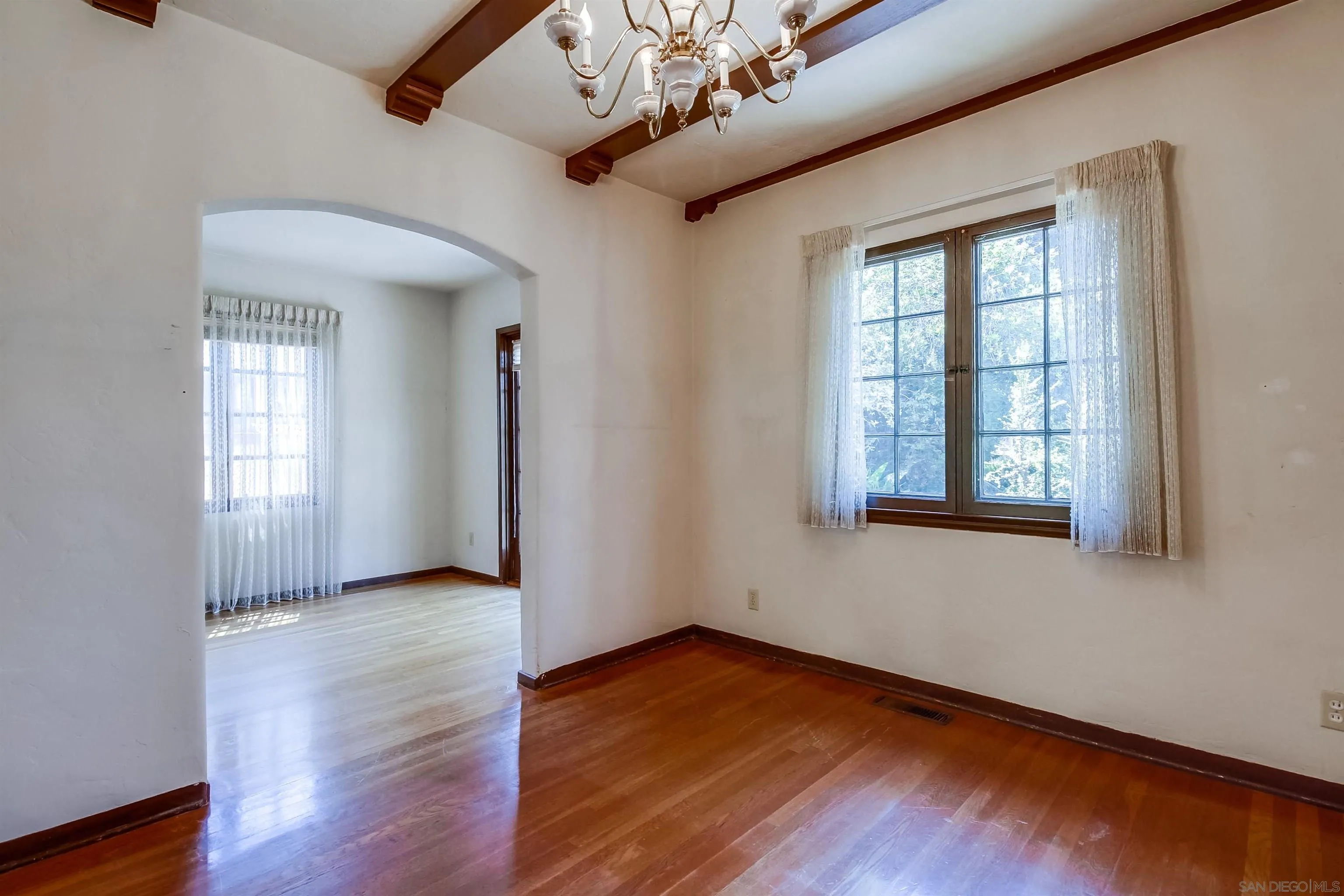340 B Avenue Coronado, CA 92118 - Photo 13 of 31 a view of an empty room with wooden floor and a window