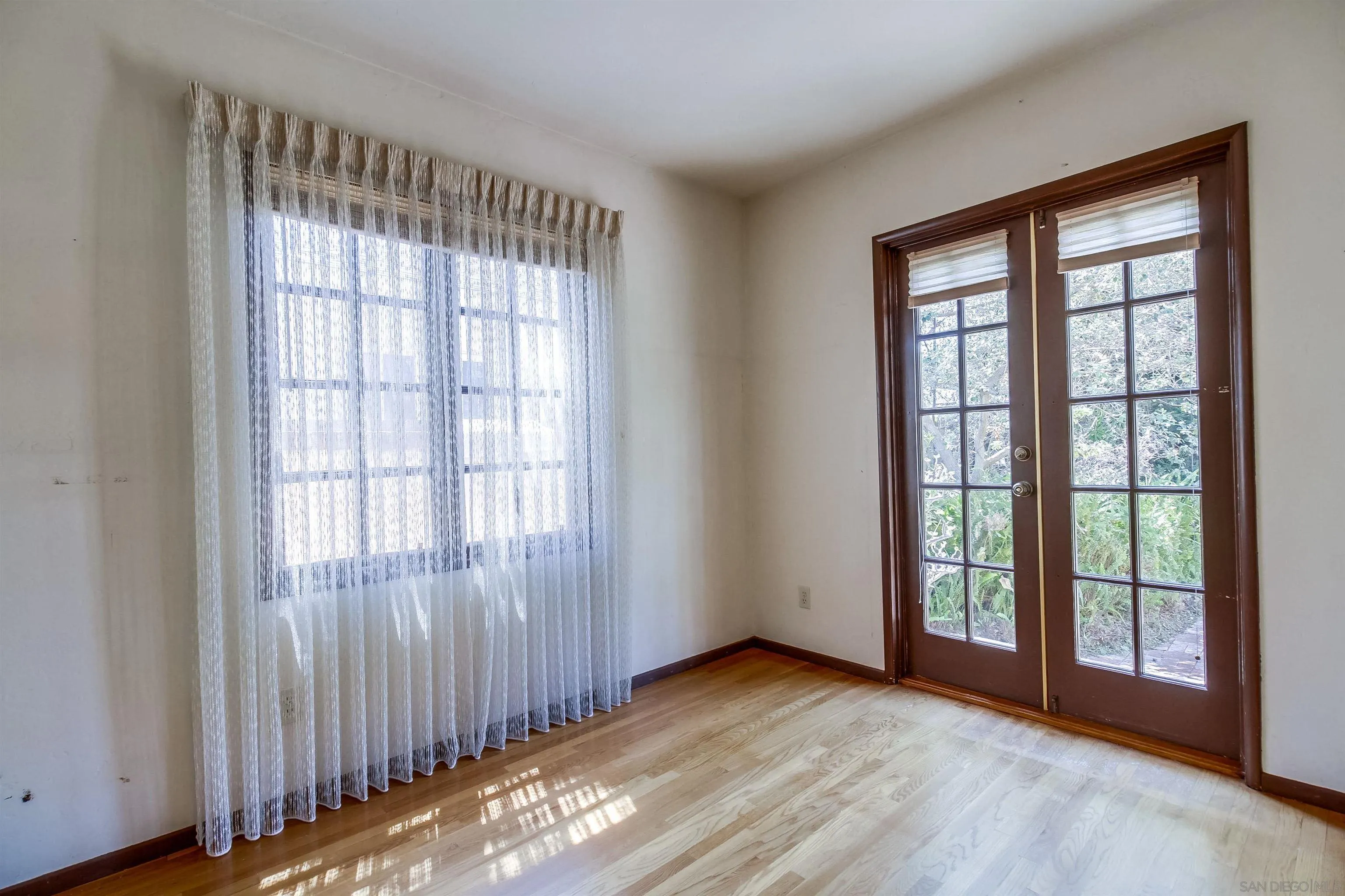 340 B Avenue Coronado, CA 92118 - Photo 14 of 31 a view of an empty room with wooden floor and a window