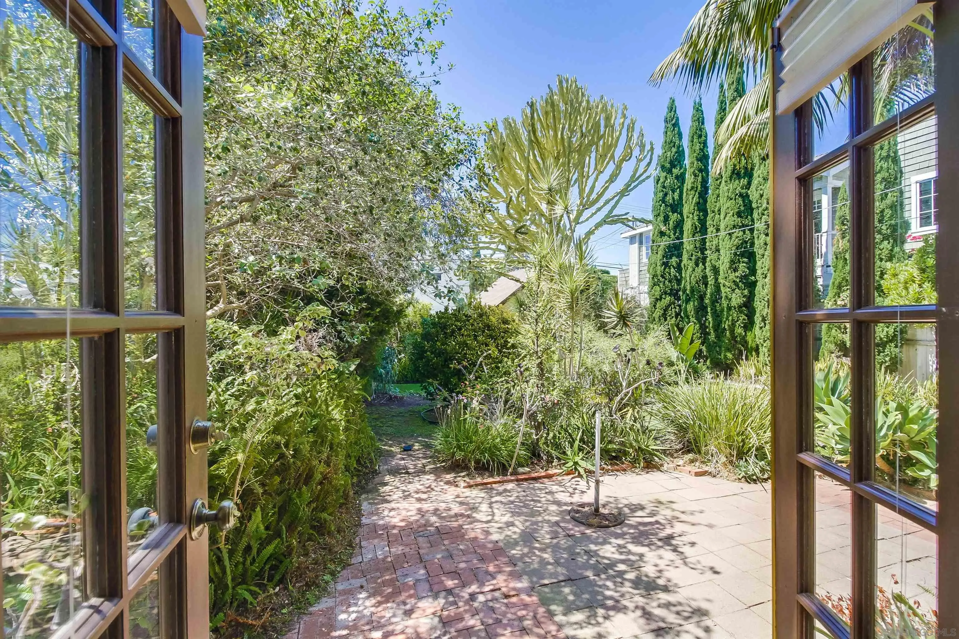 340 B Avenue Coronado, CA 92118 - Photo 15 of 31 a view of a yard with plants and brick wall