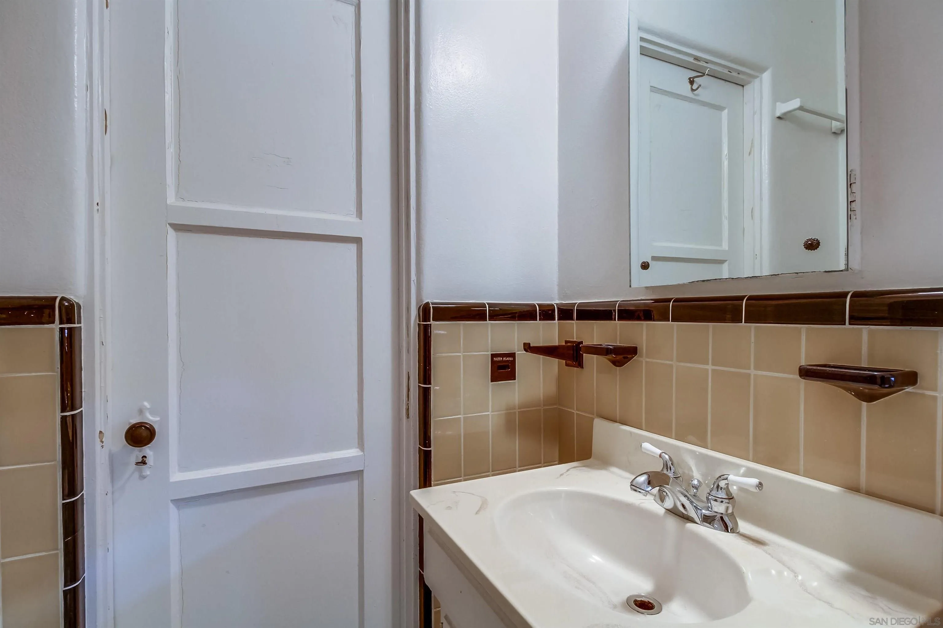 340 B Avenue Coronado, CA 92118 - Photo 17 of 31 a bathroom with a sink and a mirror