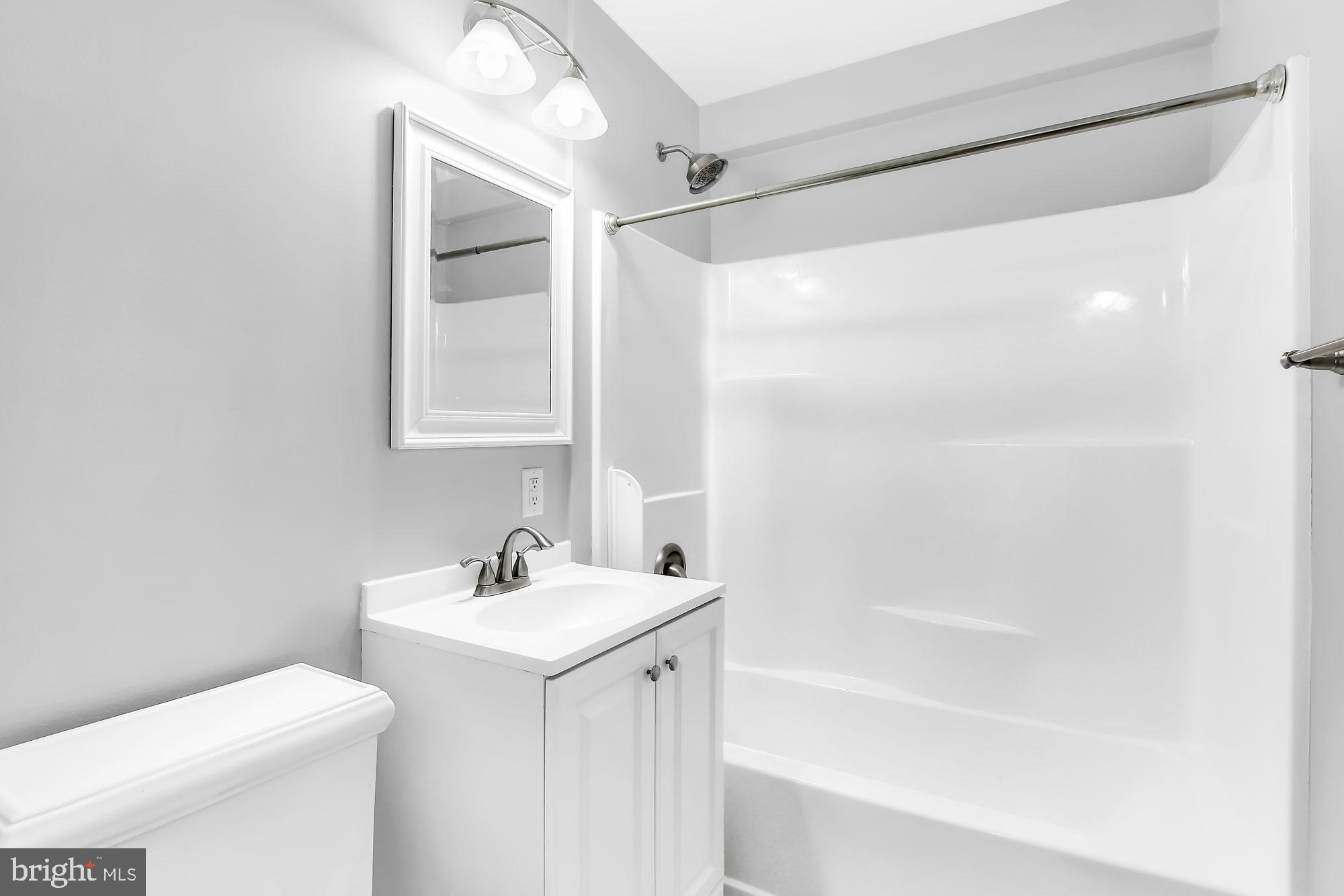 38 Kollman Drive Newark, DE 19713 - Photo 15 of 23 a bathroom with a bathtub shower sink vanity and a toilet