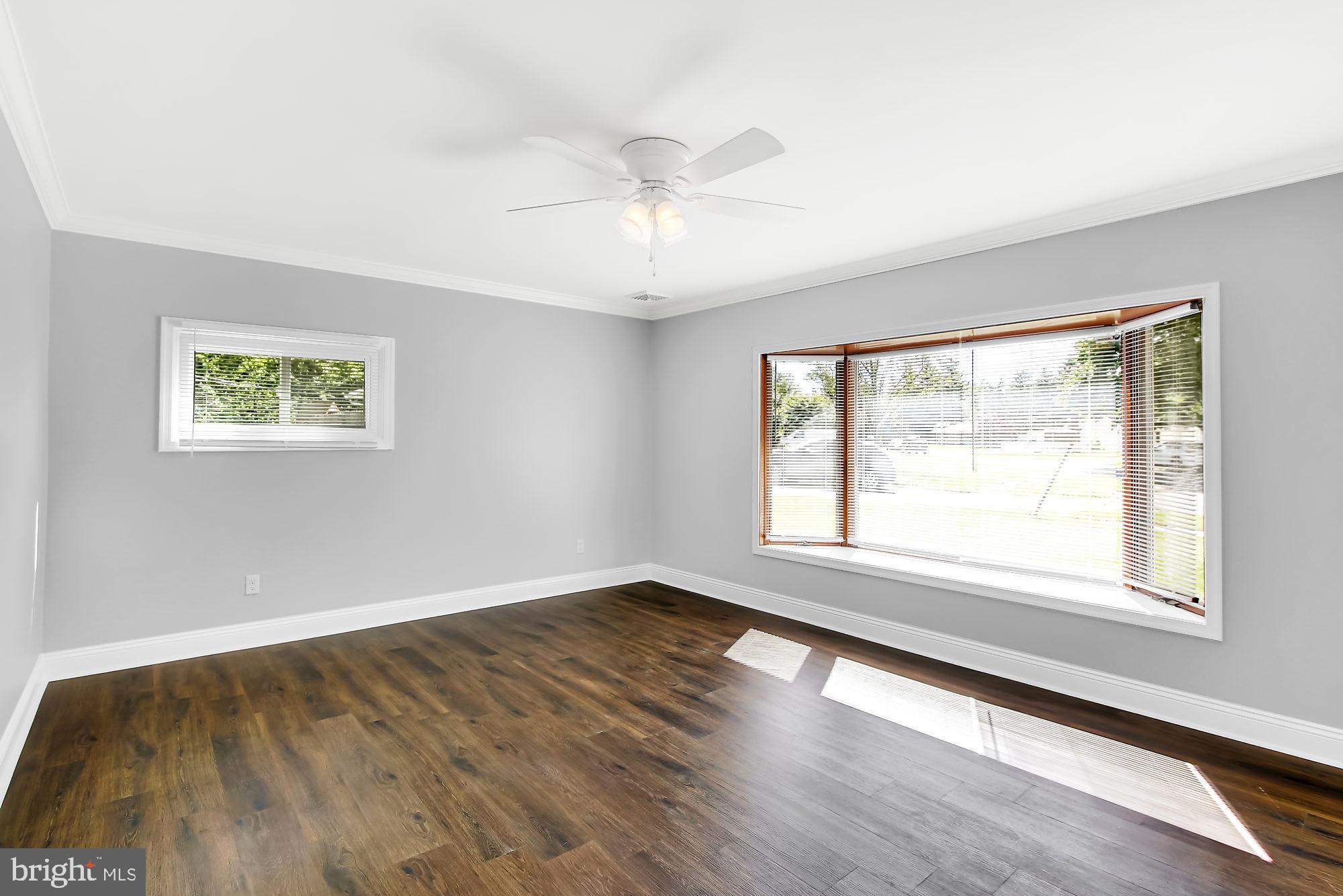 38 Kollman Drive Newark, DE 19713 - Photo 2 of 23 a view of an empty room with wooden floor and a window