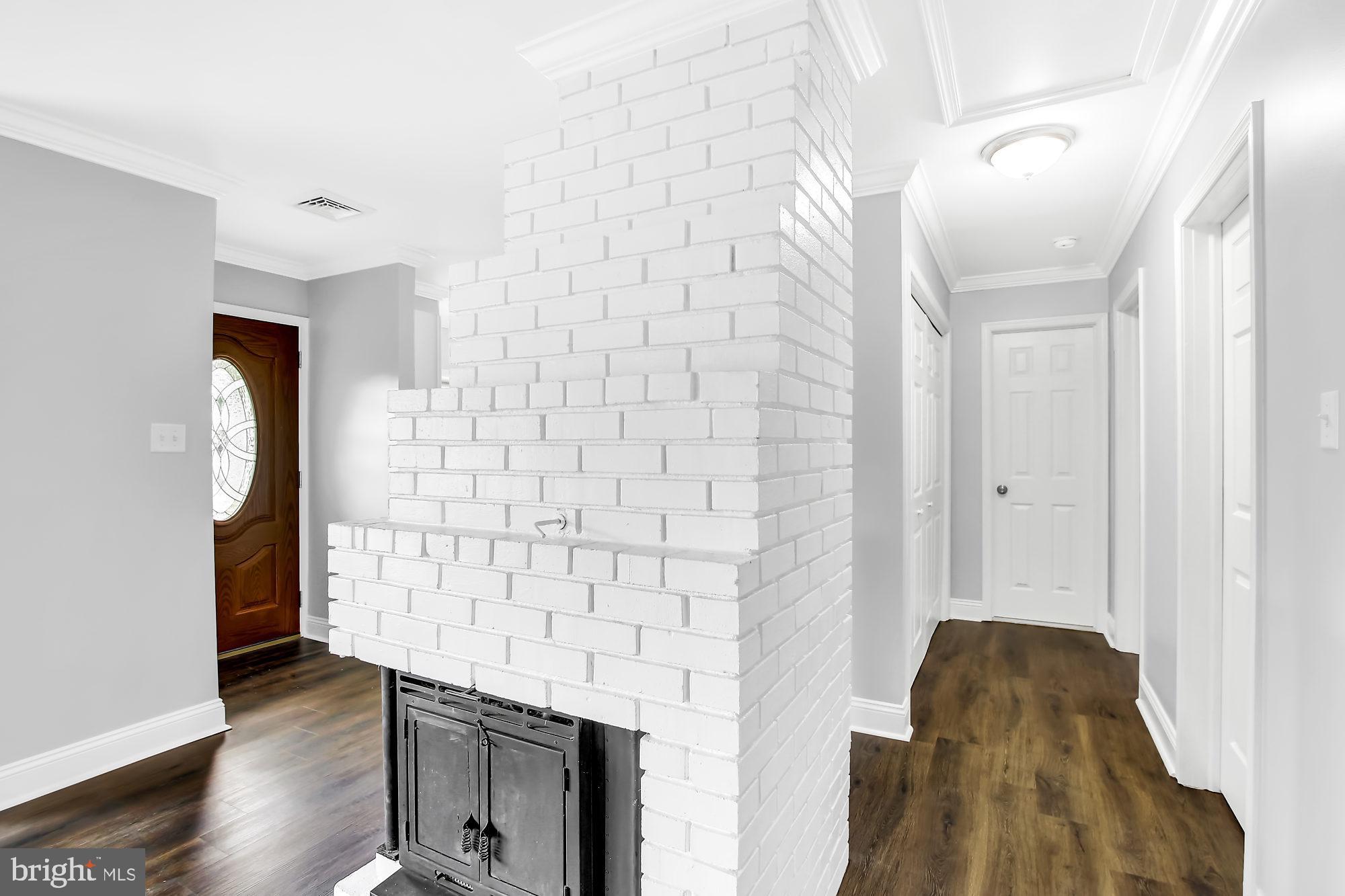 38 Kollman Drive Newark, DE 19713 - Photo 4 of 23 a living room with a fireplace and a wooden floor