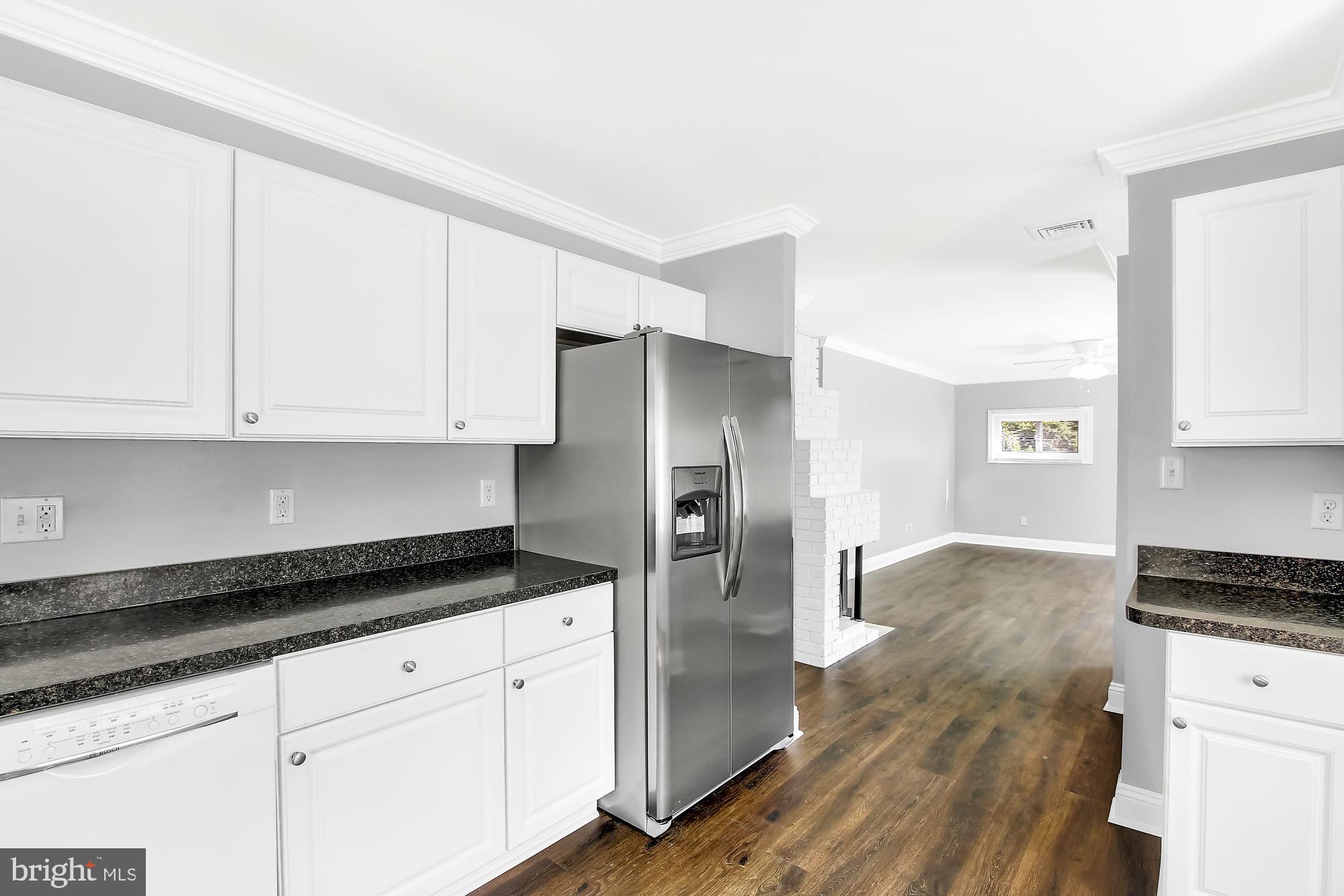 38 Kollman Drive Newark, DE 19713 - Photo 6 of 23 a kitchen with granite countertop white cabinets and stainless steel appliances