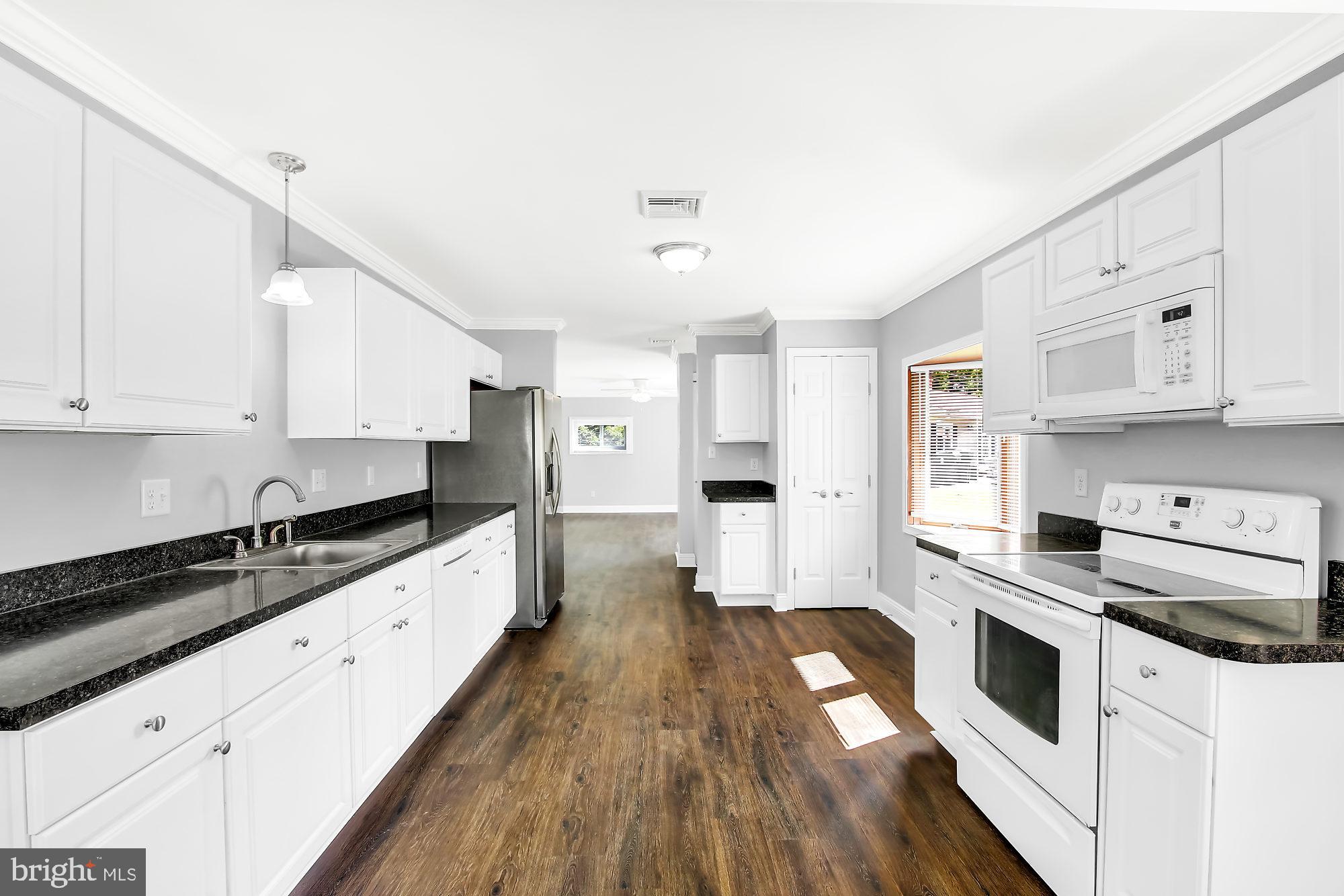 38 Kollman Drive Newark, DE 19713 - Photo 7 of 23 a kitchen with stainless steel appliances a stove sink and cabinets
