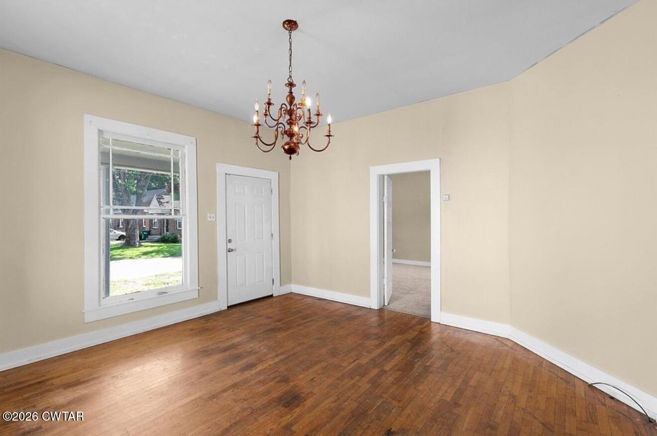 125 Williams Street Jackson, TN 38301 - Photo 5 of 17 a view of an empty room with a window and wooden floor