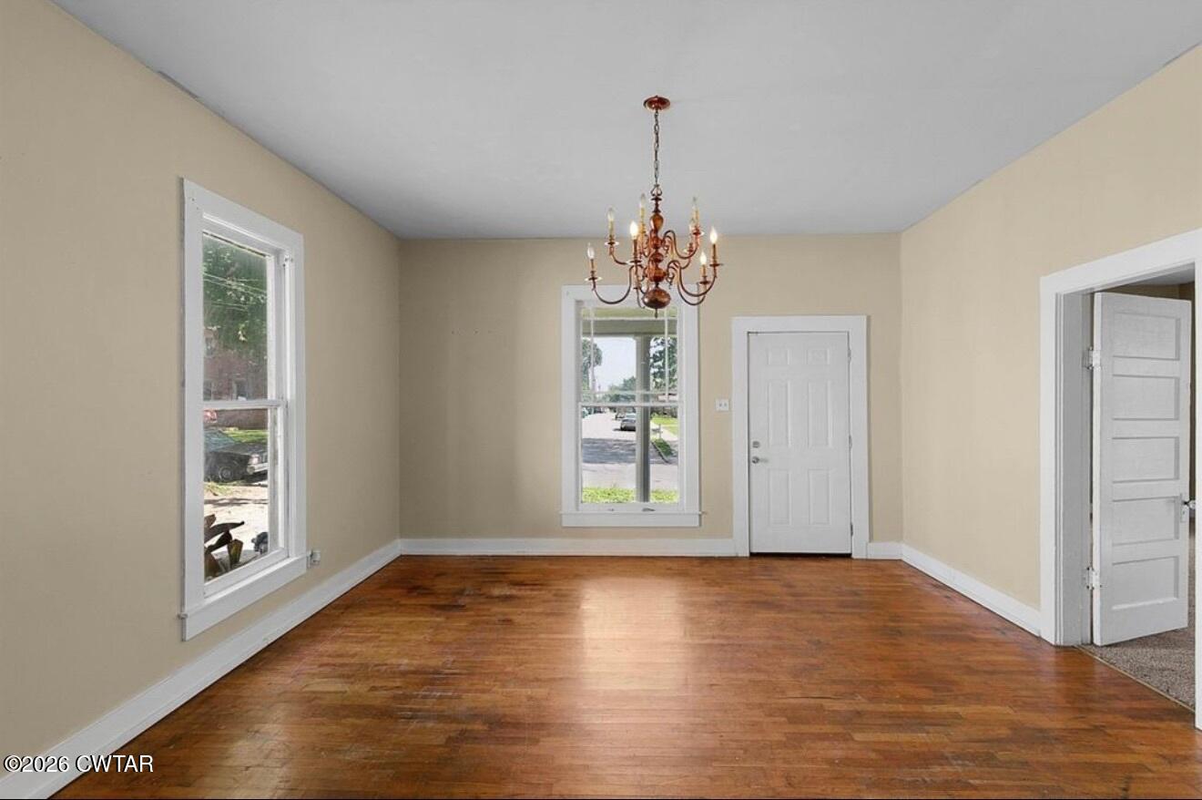 125 Williams Street Jackson, TN 38301 - Photo 6 of 17 a view of an empty room with wooden floor and a window