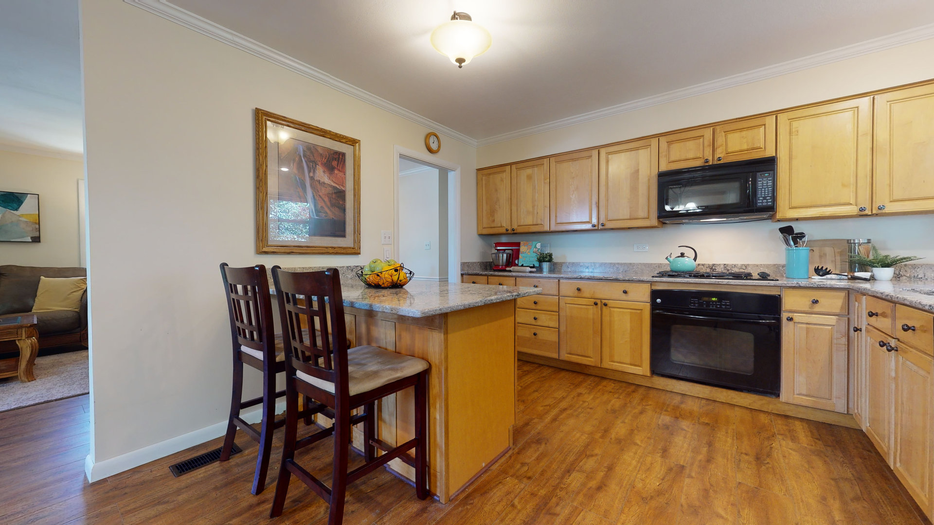 274 Timber Hill Road Buffalo Grove, IL 60089 - Photo 6 of 22 a kitchen with stainless steel appliances granite countertop a stove top oven a sink a dining table and chairs with wooden floor