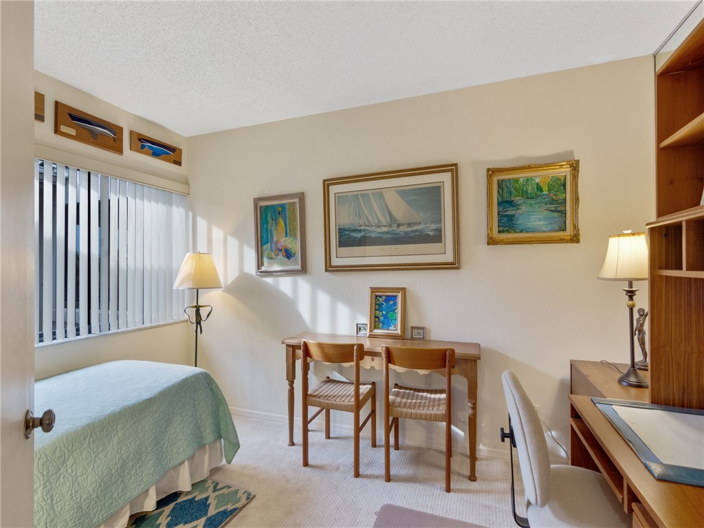 1880 Bay Road, Unit I319 Vero Beach, FL 32963 - Photo 16 of 36 a bedroom with a bed and a desk
