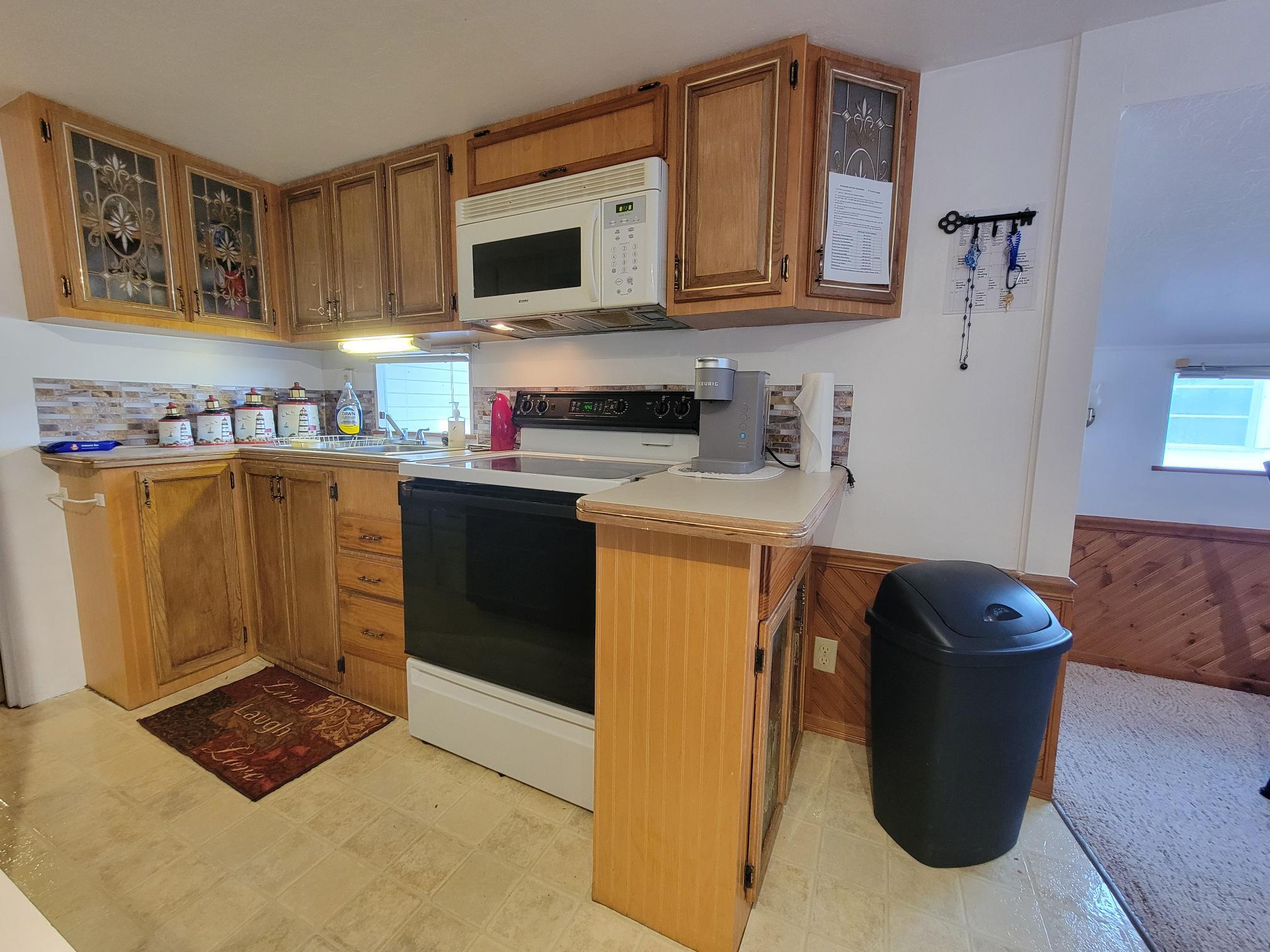 13690 Northwest 127th Terrace Okeechobee, FL 34974 - Photo 11 of 23 a kitchen with a refrigerator sink and cabinets