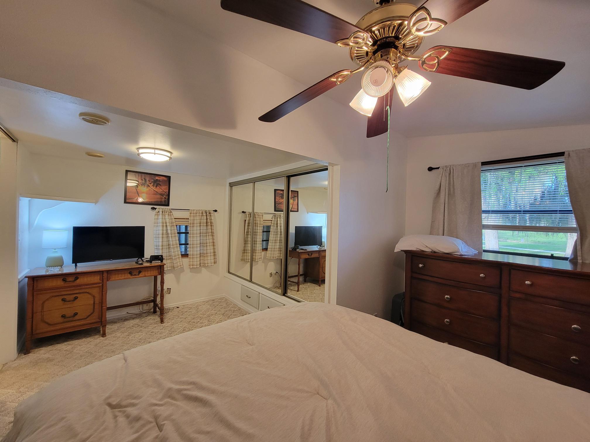 13690 Northwest 127th Terrace Okeechobee, FL 34974 - Photo 16 of 23 a bedroom with a bed and a flat screen tv
