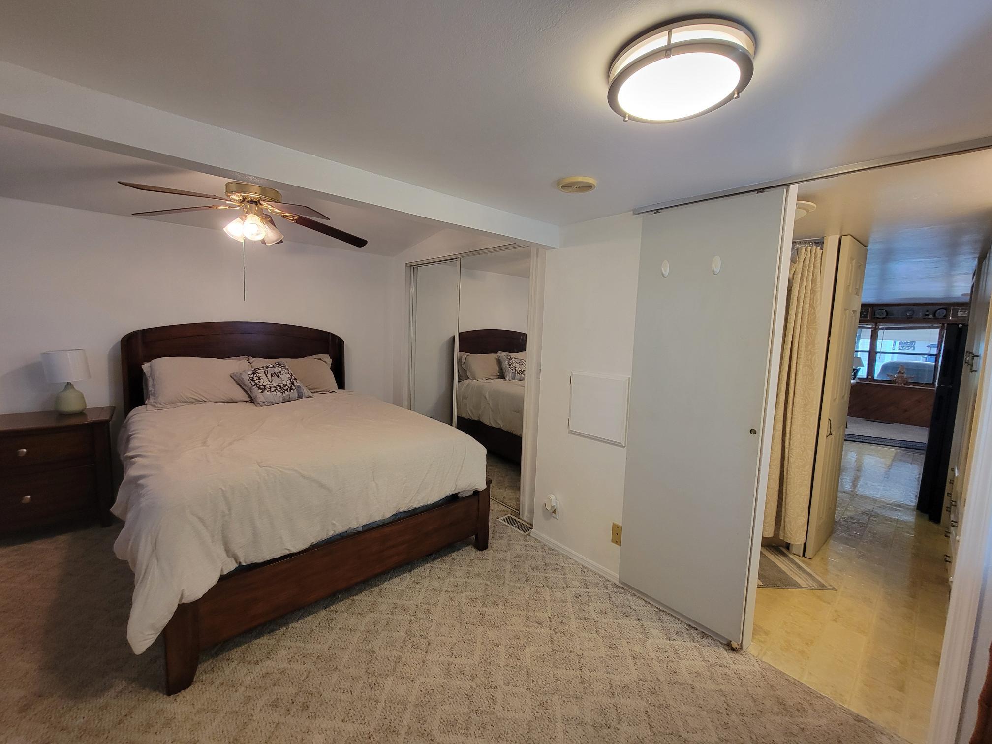 13690 Northwest 127th Terrace Okeechobee, FL 34974 - Photo 17 of 23 a bedroom with a bed and a view of bathroom