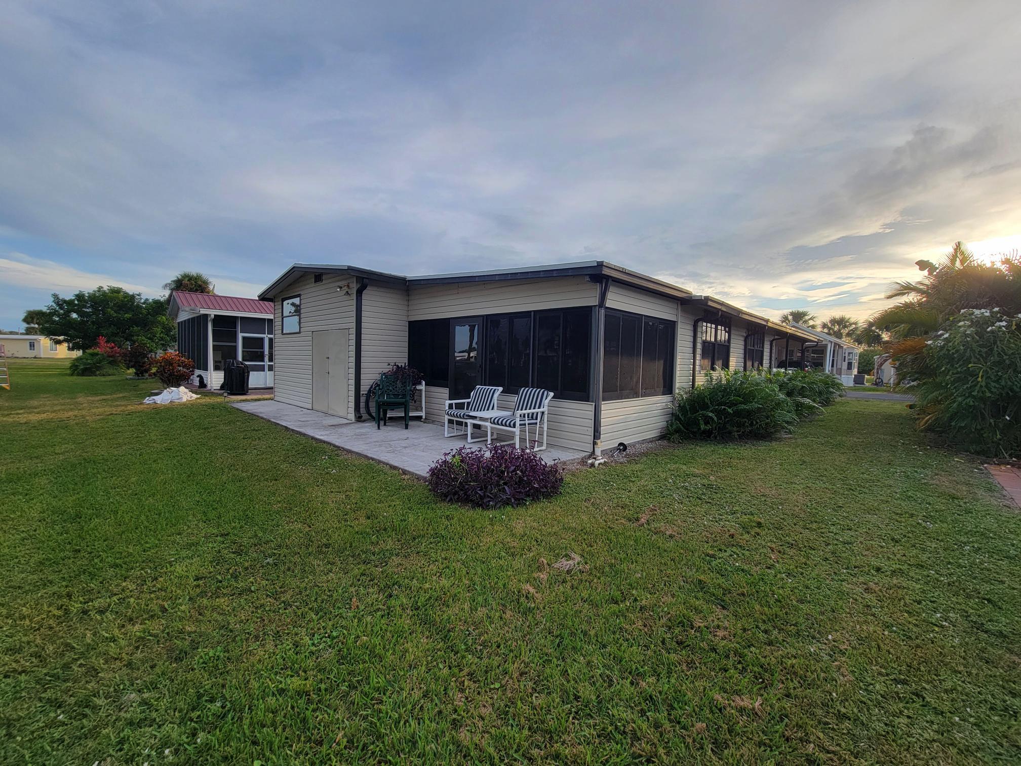 13690 Northwest 127th Terrace Okeechobee, FL 34974 - Photo 22 of 23 a view of a house with a back yard