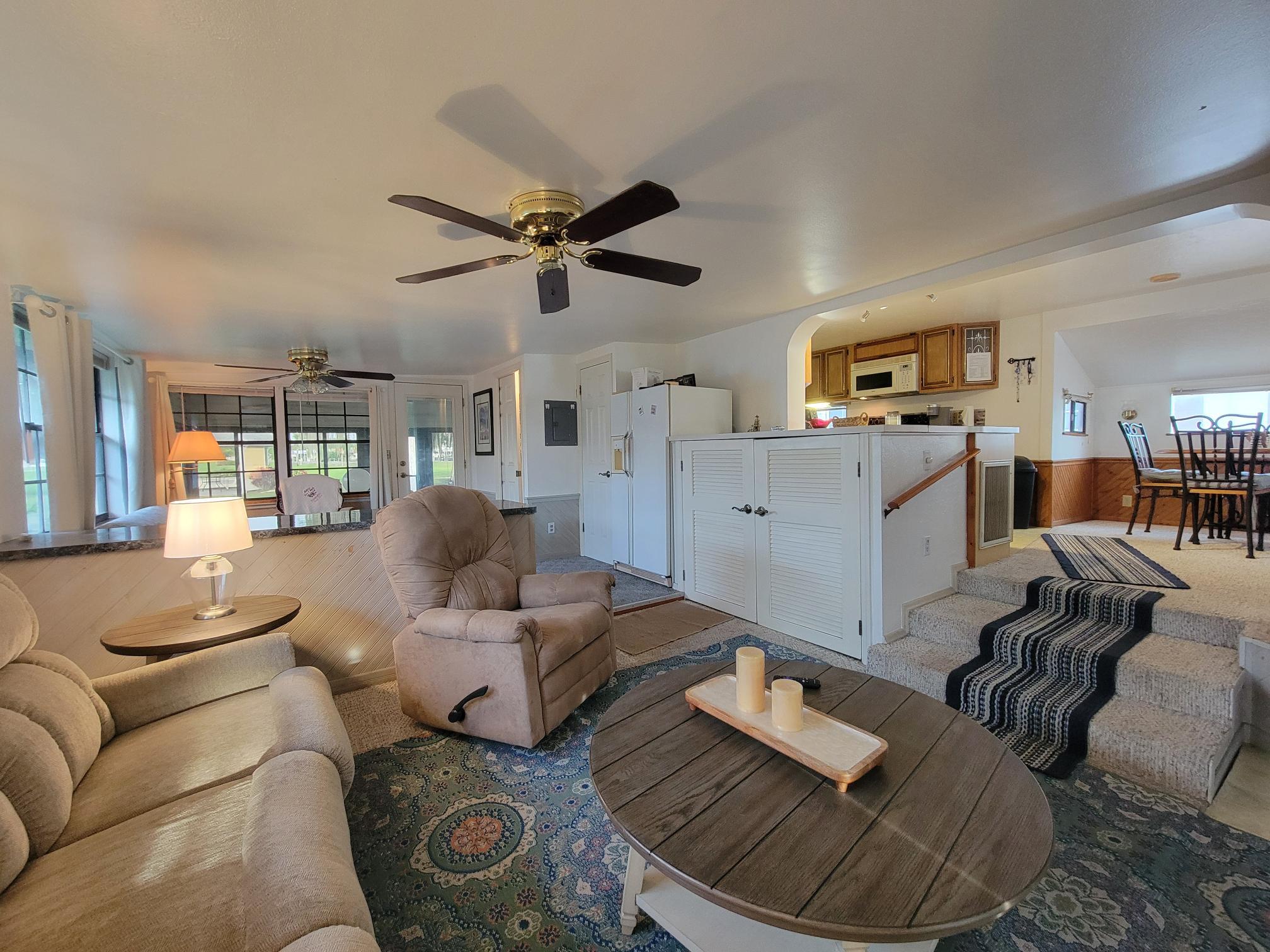 13690 Northwest 127th Terrace Okeechobee, FL 34974 - Photo 8 of 23 a living room with furniture and a wooden floor