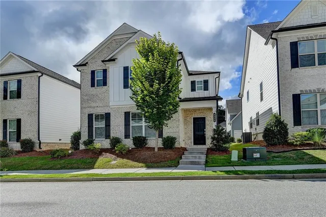 a front view of house with yard and green space