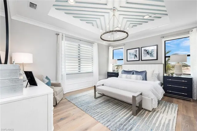 a bedroom with a bed and a chandelier