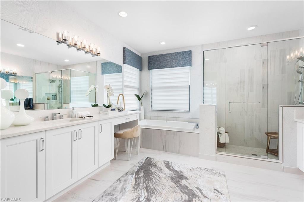 21065 Teak Tree Terrace Estero, FL 33928 - Photo 5 of 15 a bathroom with a granite countertop sink mirror and a bathtub