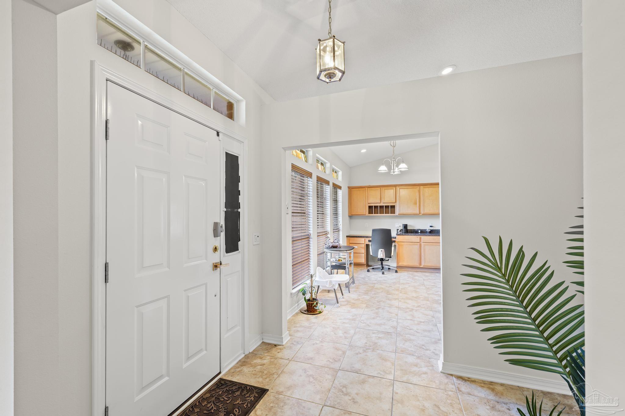 2165 Liberty Loop Road Cantonment, FL 32533 - Photo 11 of 51 a hallway with a white table and chairs