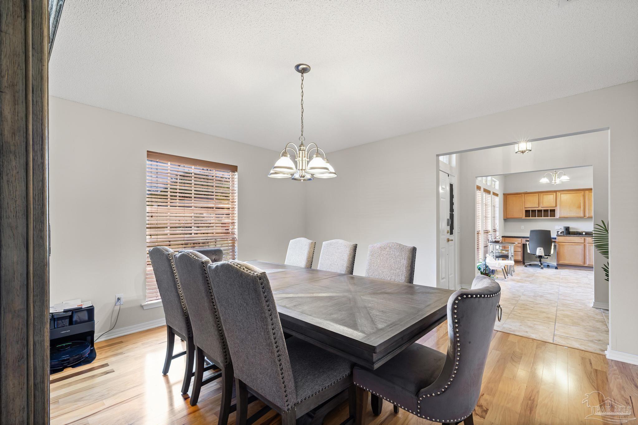 2165 Liberty Loop Road Cantonment, FL 32533 - Photo 12 of 51 a view of a dining room with furniture window and wooden floor