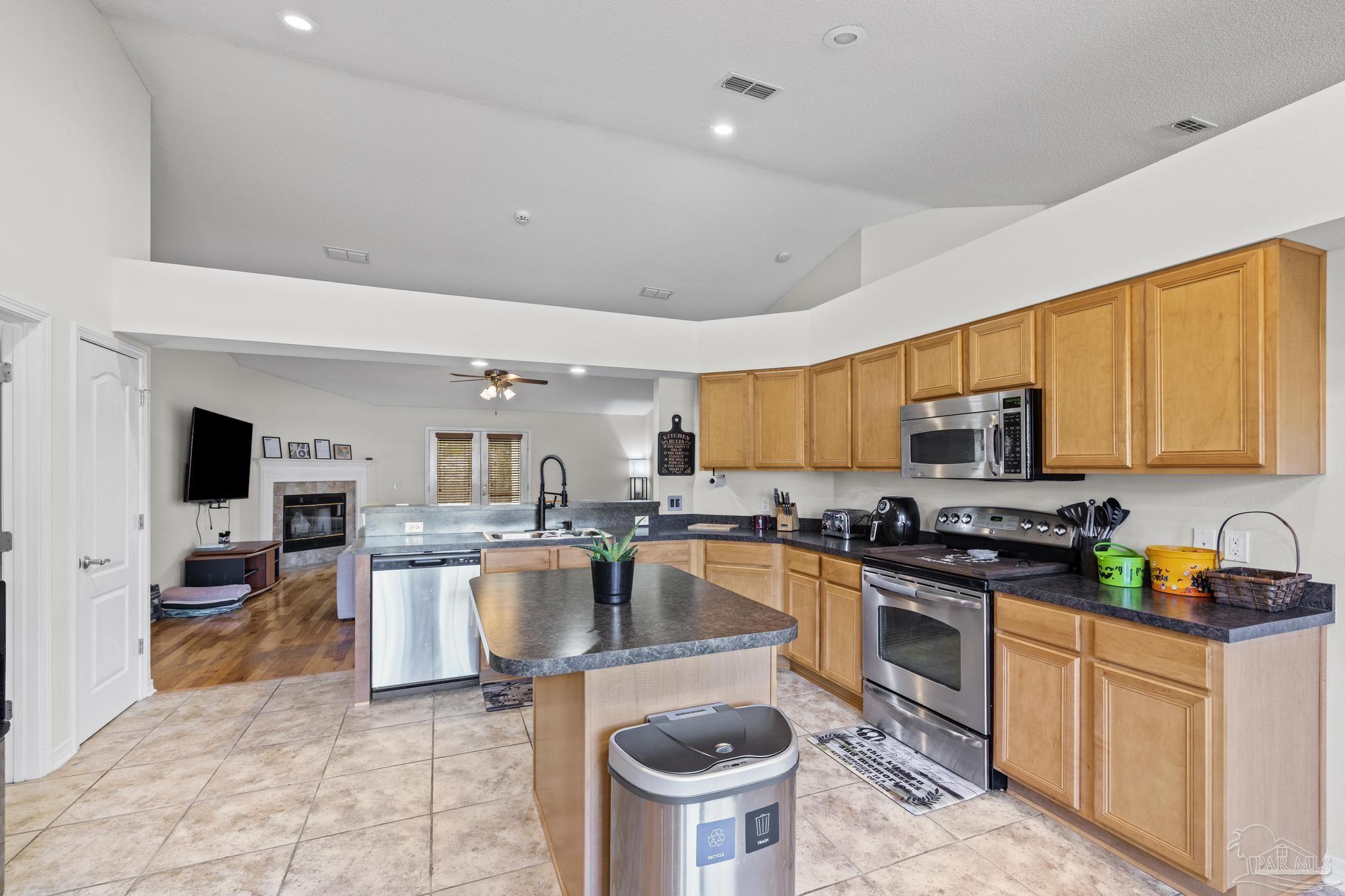 2165 Liberty Loop Road Cantonment, FL 32533 - Photo 24 of 51 a kitchen with sink a stove and cabinets