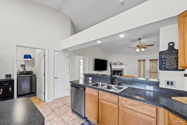 a kitchen with sink a stove and cabinets