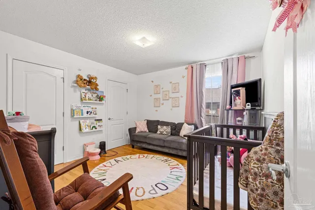 a bedroom with furniture and baby crib