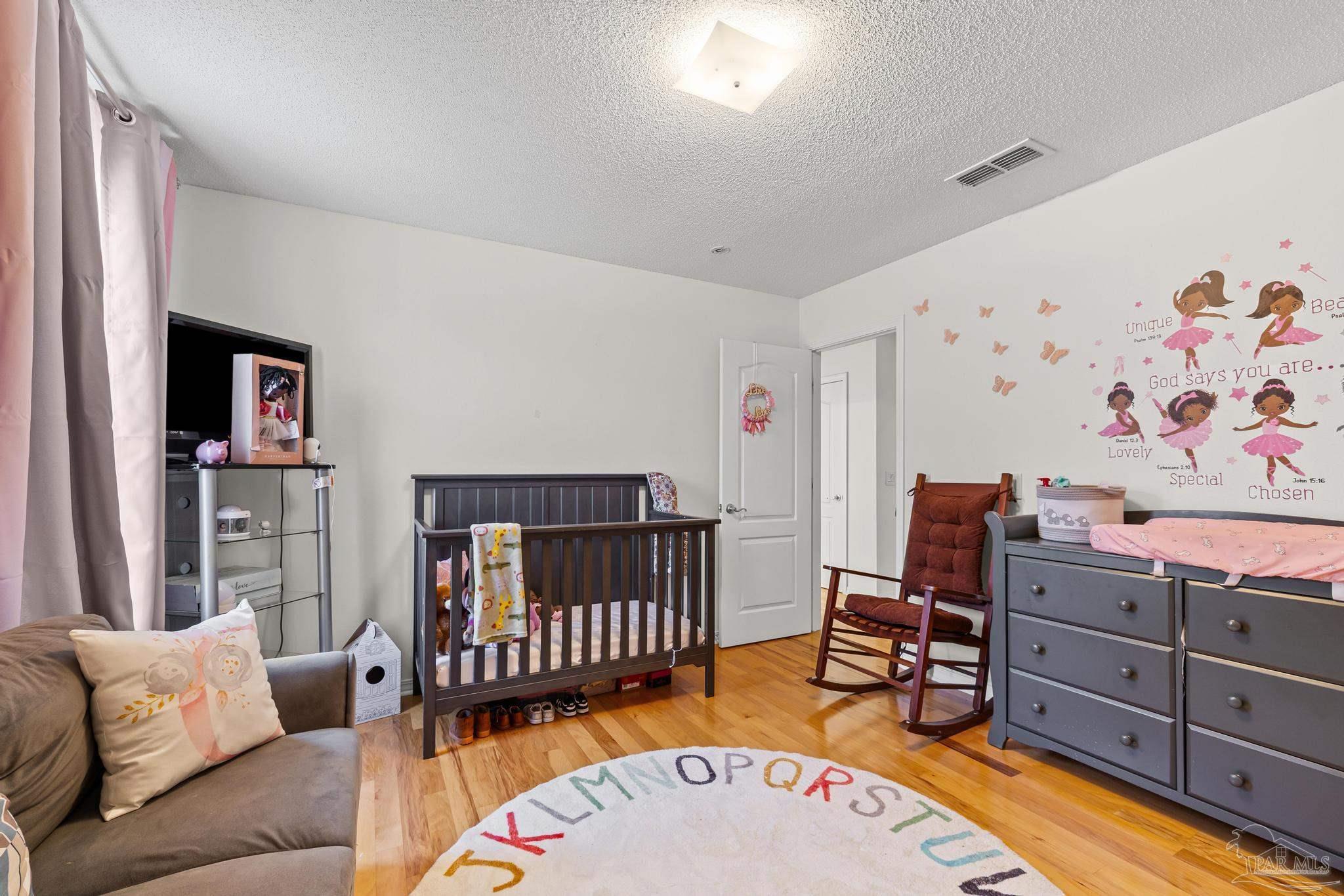 2165 Liberty Loop Road Cantonment, FL 32533 - Photo 31 of 51 a bedroom with furniture and baby crib