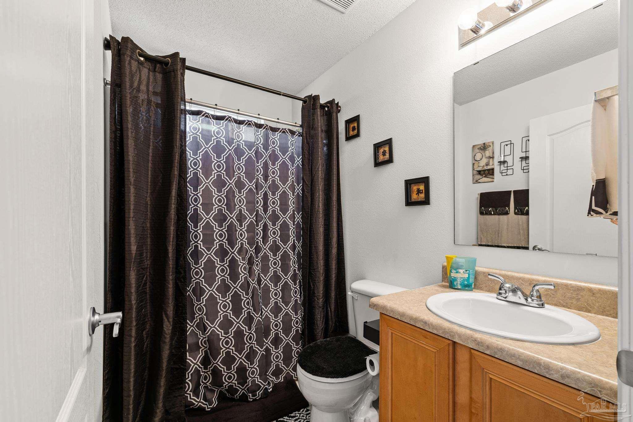 2165 Liberty Loop Road Cantonment, FL 32533 - Photo 35 of 51 a bathroom with a sink toilet and shower