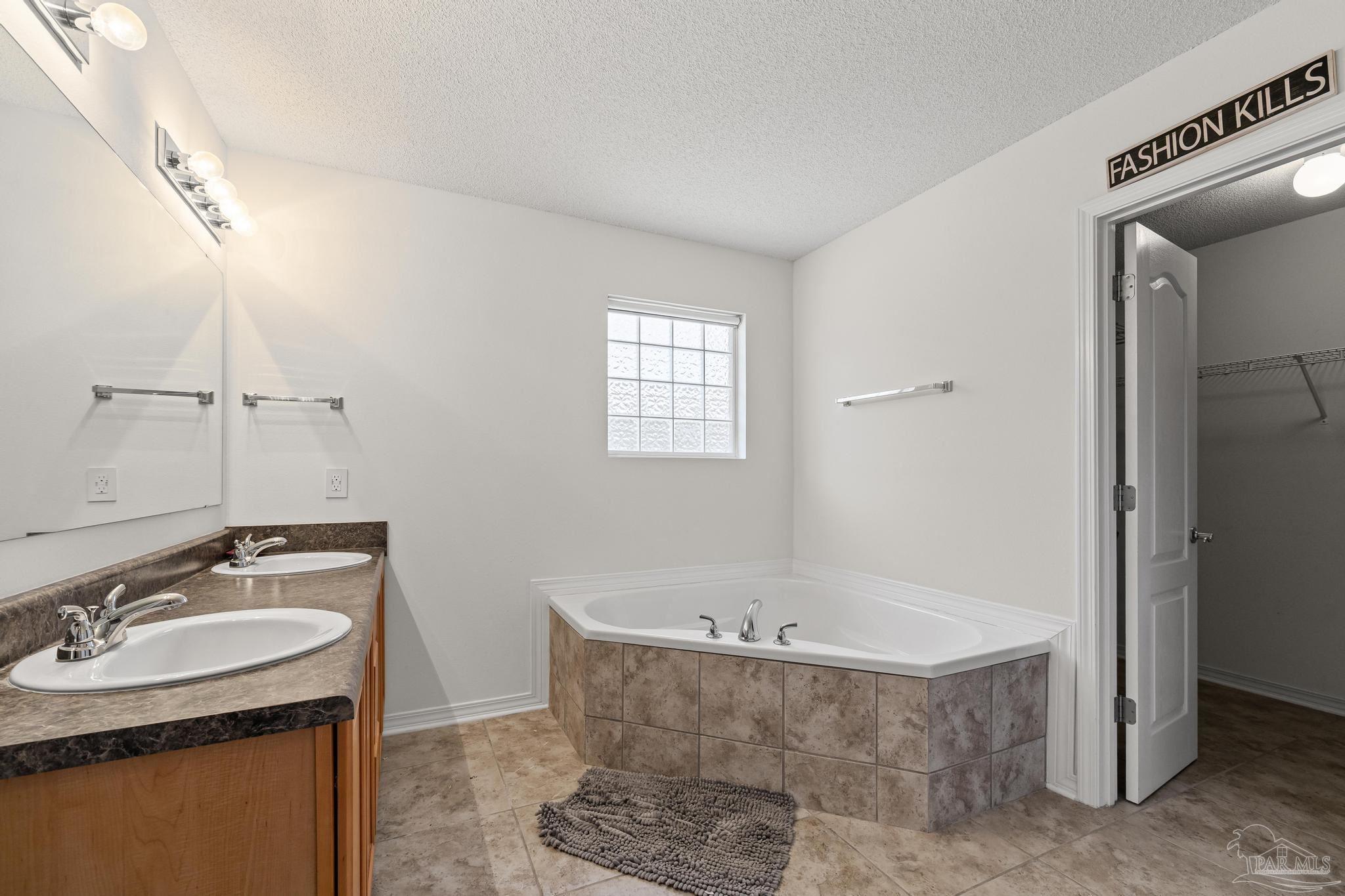 2165 Liberty Loop Road Cantonment, FL 32533 - Photo 38 of 51 a bathroom with a tub sink and mirror