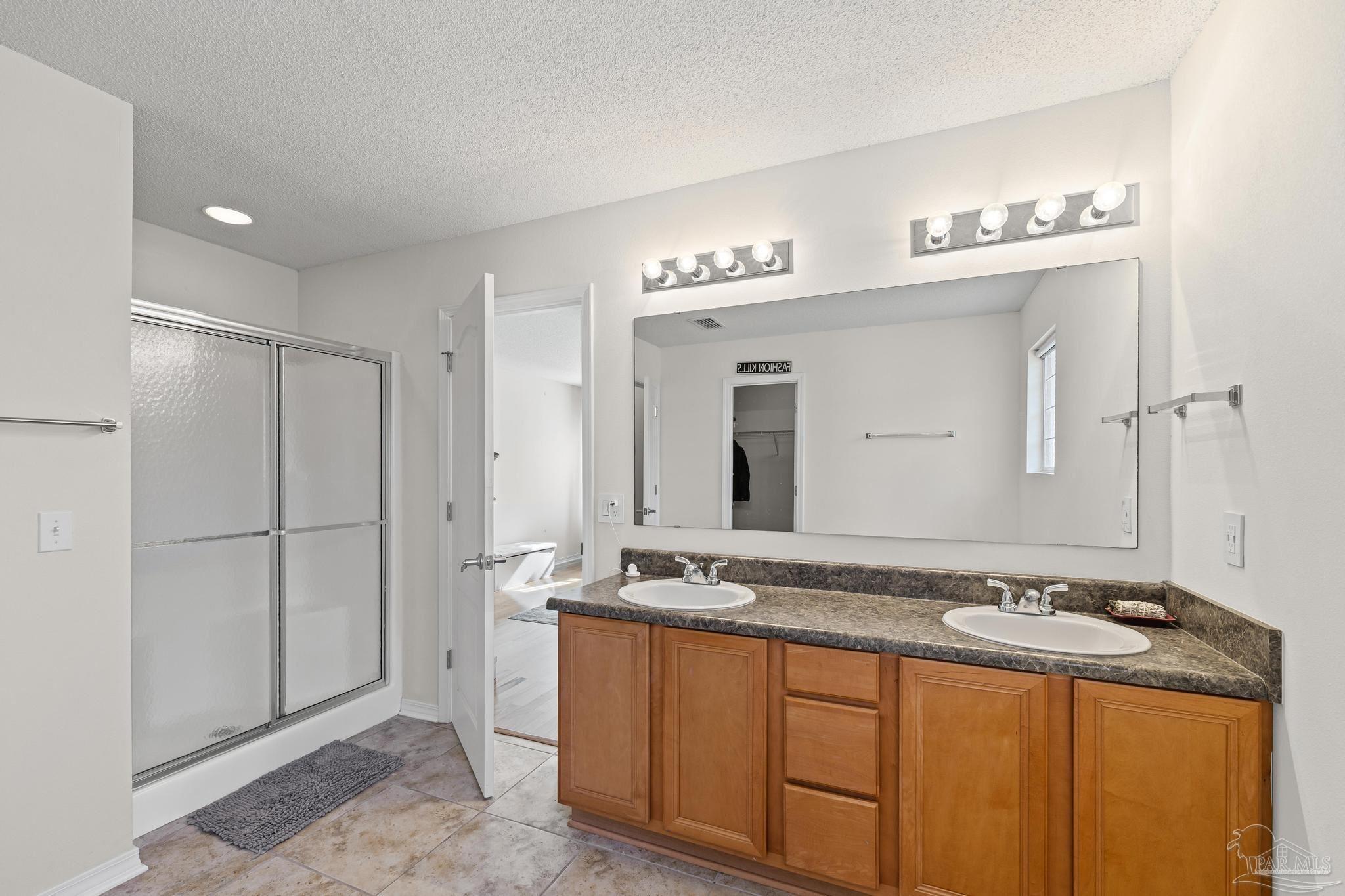 2165 Liberty Loop Road Cantonment, FL 32533 - Photo 39 of 51 a spacious bathroom with a granite countertop sink and a mirror