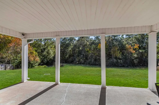 a view of a porch with furniture and garden