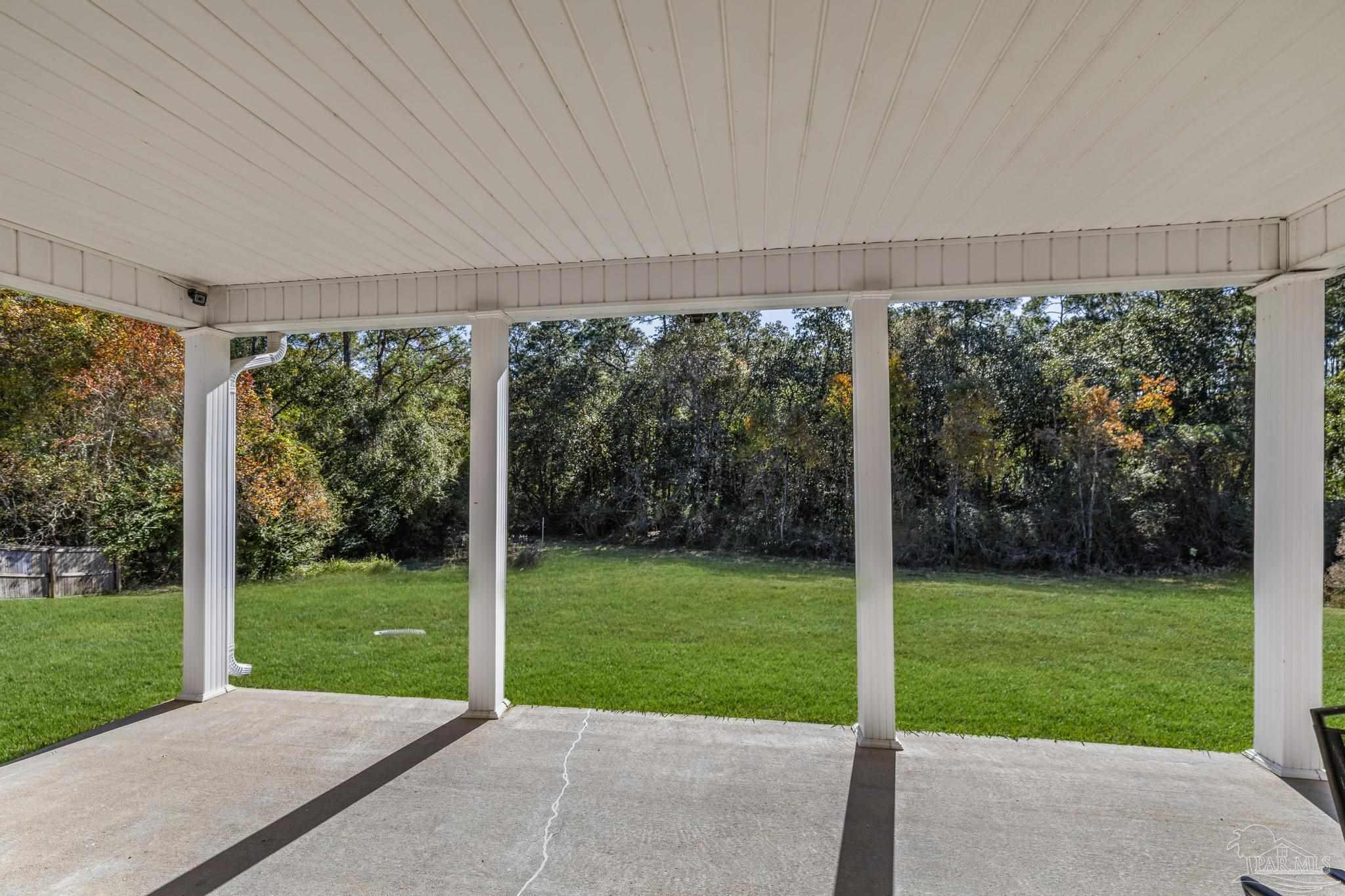 2165 Liberty Loop Road Cantonment, FL 32533 - Photo 41 of 51 a view of a porch with a big yard potted plants and large tree