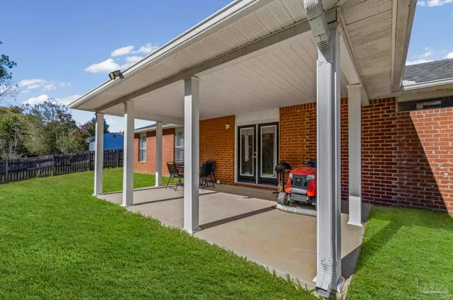 a view of a grassy field with trees in the background