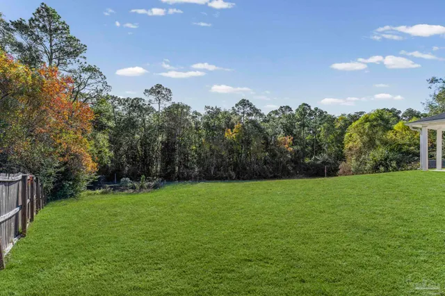 a view of a house with a yard and sitting area