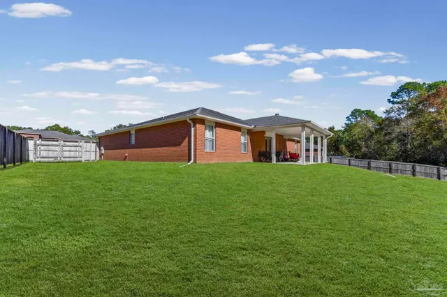 a view of a house with a backyard