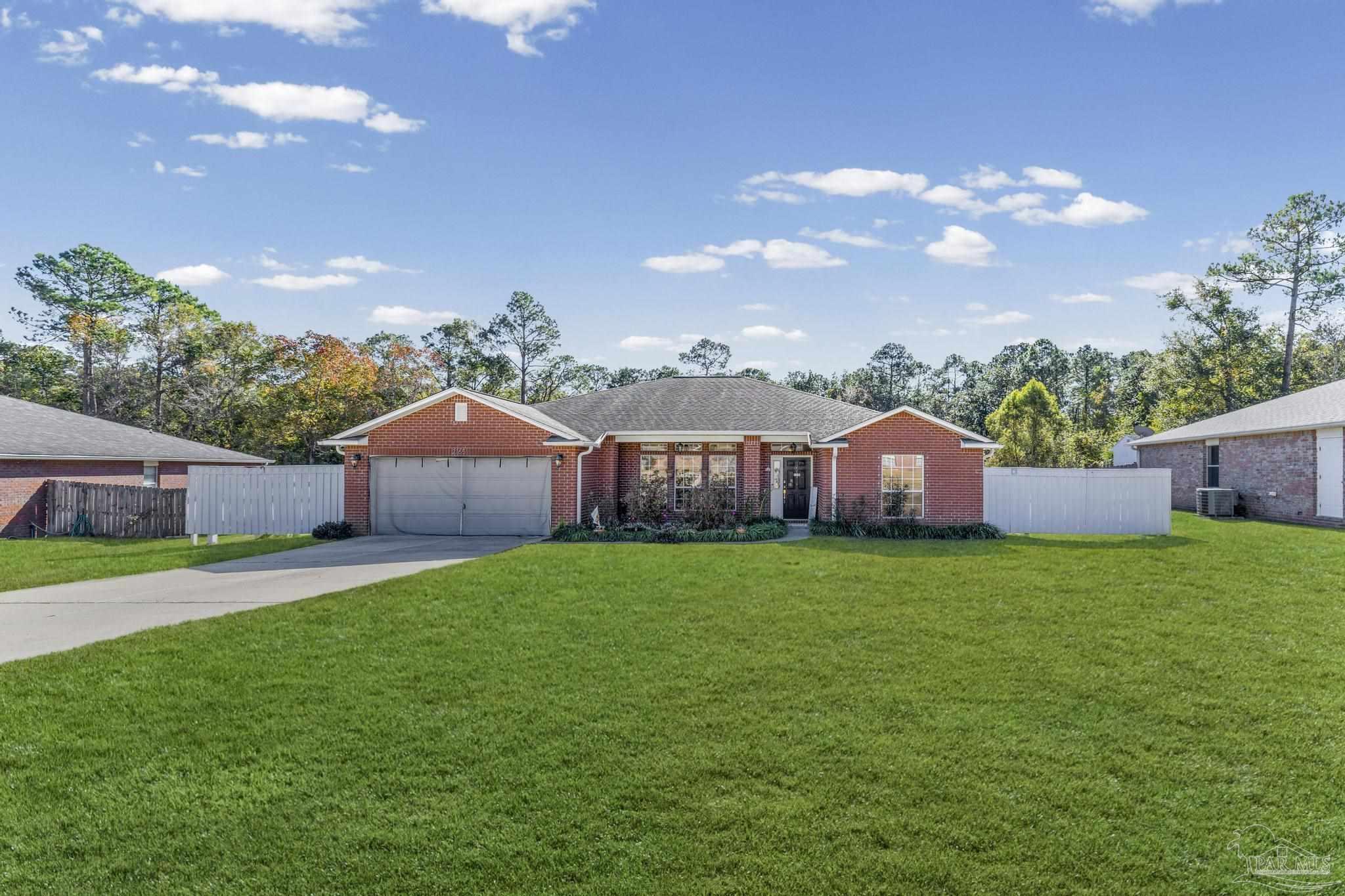 2165 Liberty Loop Road Cantonment, FL 32533 - Photo 6 of 51 a front view of a house with garden