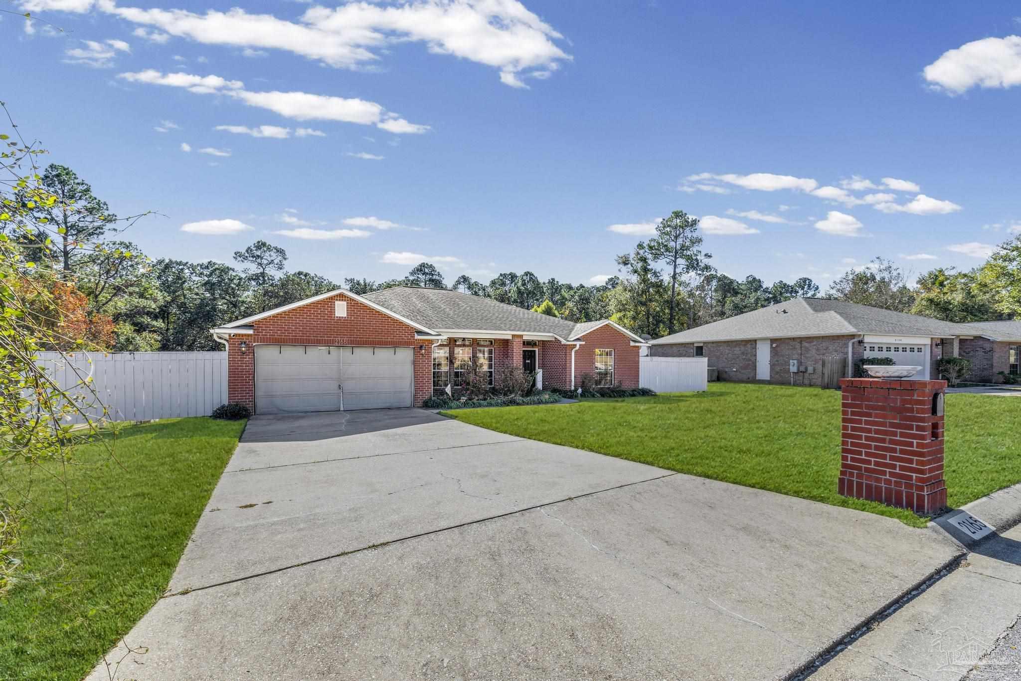 2165 Liberty Loop Road Cantonment, FL 32533 - Photo 7 of 51 a front view of a house with a yard and garage