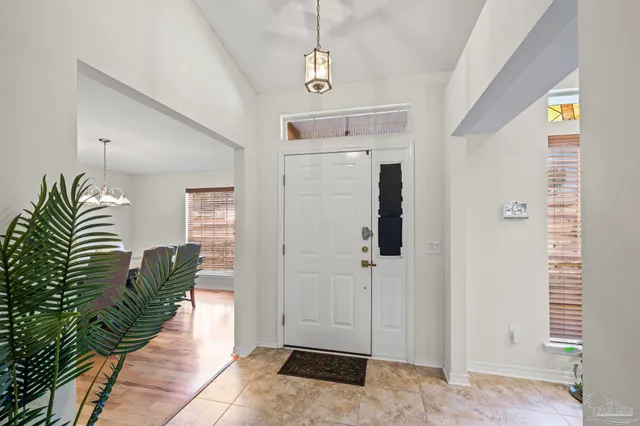 a hallway with a white table and chairs
